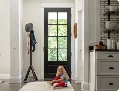 Clear 8 panel doorway with a child putting on her shoes in front of it