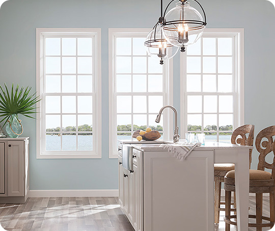 a baby blue kitchen with large MI double hung windows