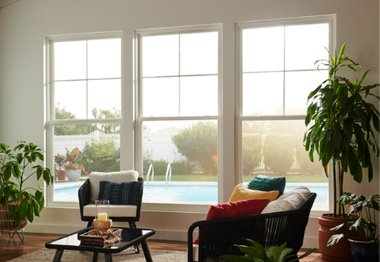 double hung windows in a minimalist living room looking out to a pool