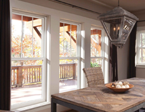 andersen 100 series single hung windows behind a kitchen table with a bowl of fruit in the middle