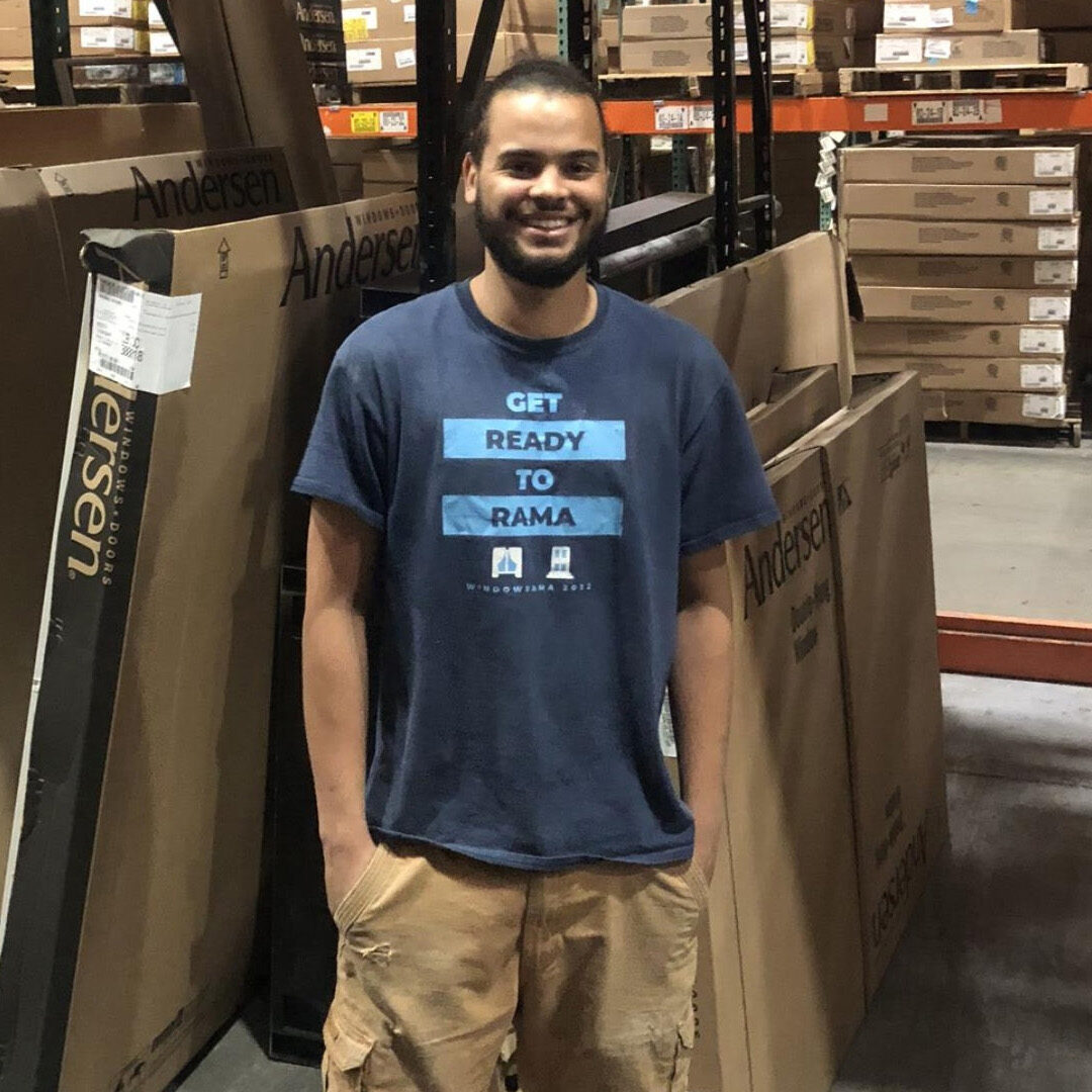 new employee at windowrama inside a warehouse