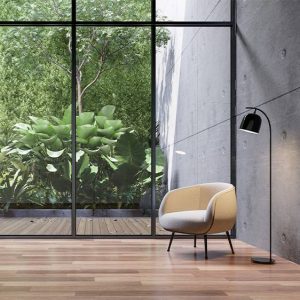 green interior design with floor to ceiling windows and a view of trees