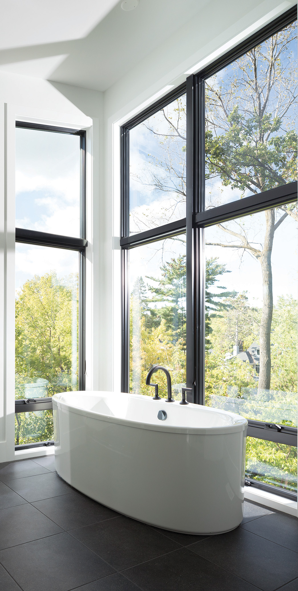 a bathtub beside a full wall window