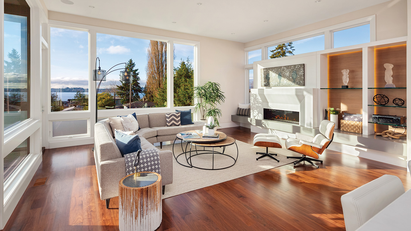 a living room with wood floors and white walls with modern décor and comfortably furnished