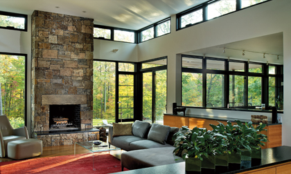 brick fireplace beside full glass wall windows