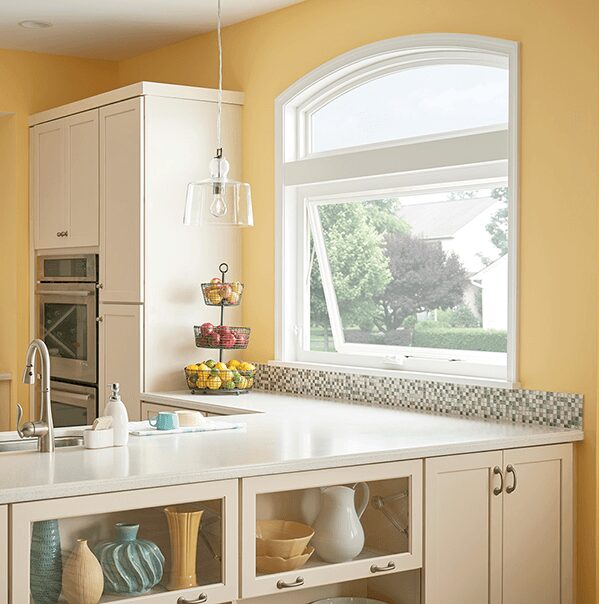 Cream painted walls in a minimalist kitchen with open awning window