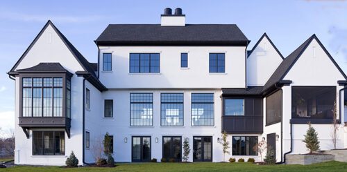 Large white 3-story home exterior with large windows