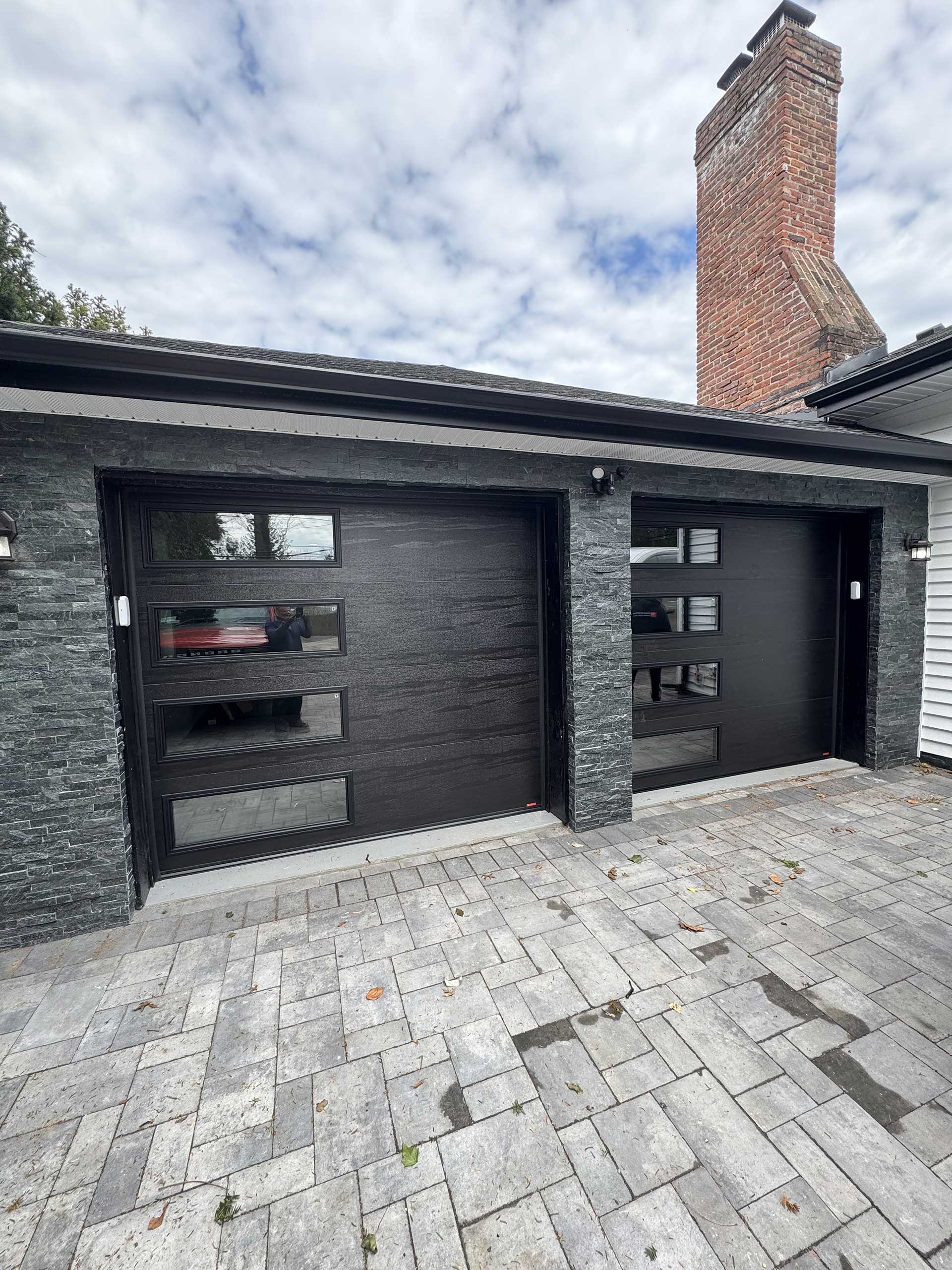 dark gray brick garage doors with flush windows on the left side
