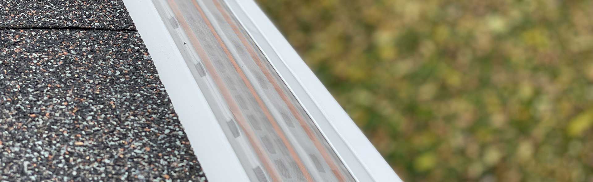 white mastershield gutter guards installed on a roof