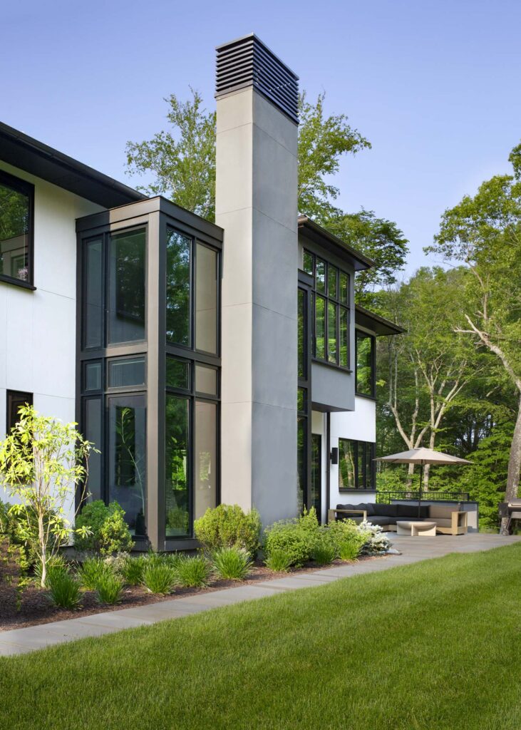 modern home exterior with full glass wall windows