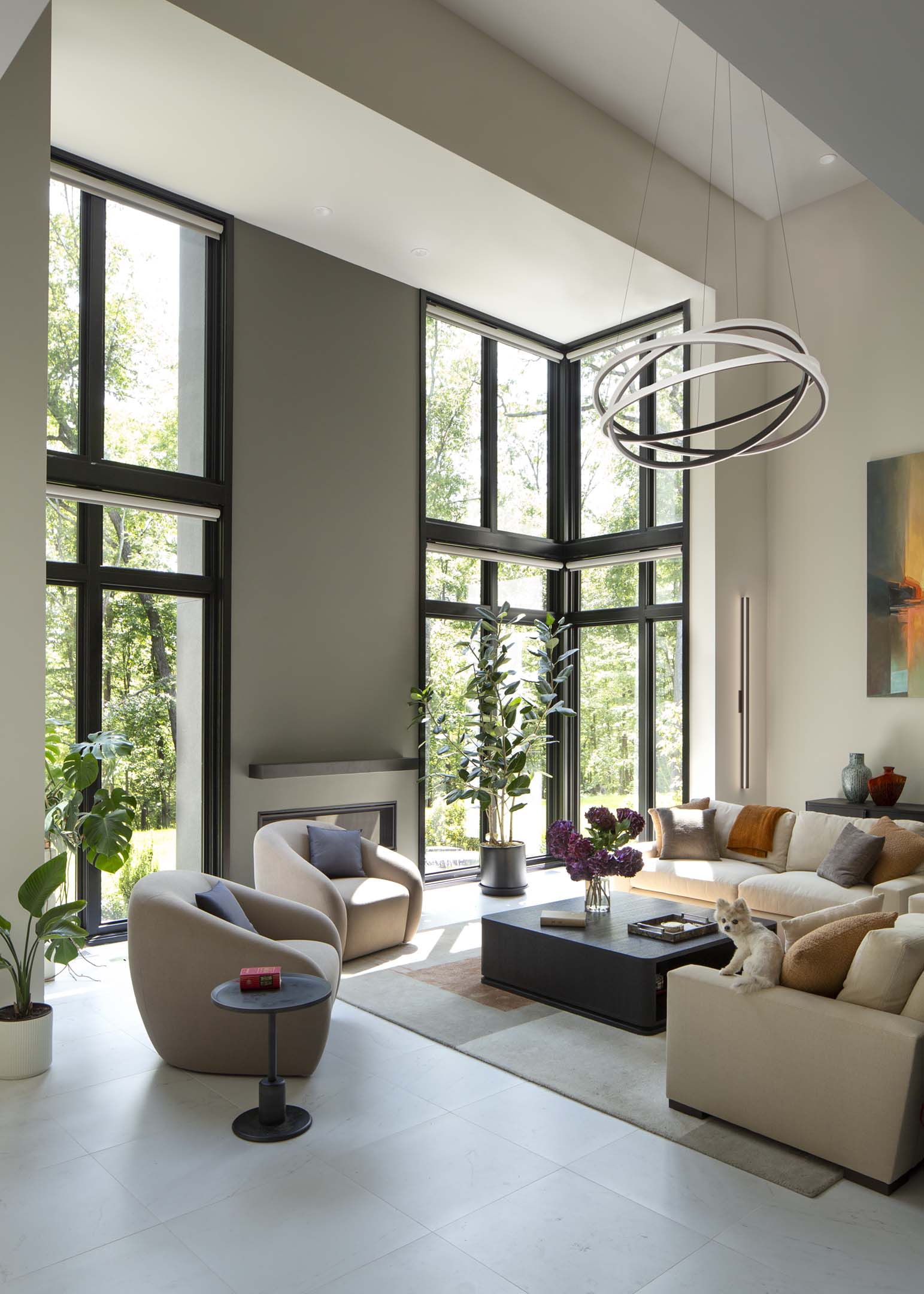 indoor cozy living room with floor to ceiling windows and black frames