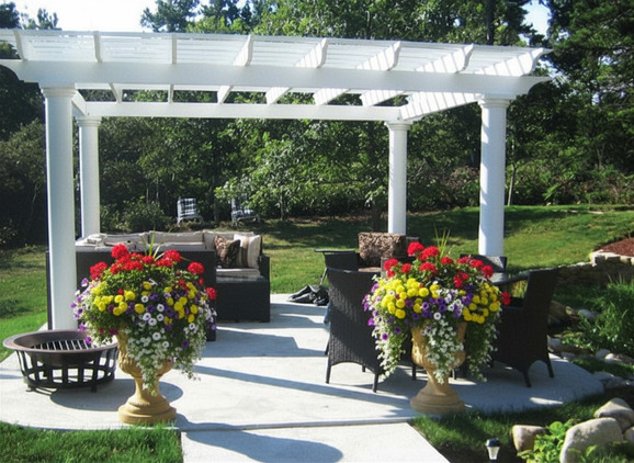 Shaded backyard patio with a pergola over an outdoor dining area