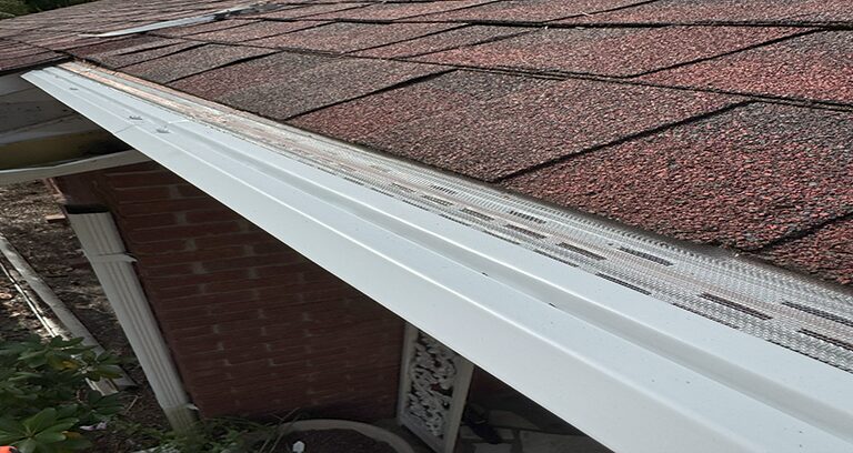 MasterShield micro-mesh gutter protection installed along the pitch of a shingled roof